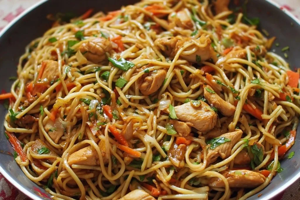 Delicious plate of best ever chicken chow mein with colorful vegetables and chicken.