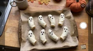 Frozen banana ghosts with white chocolate and chocolate chip faces